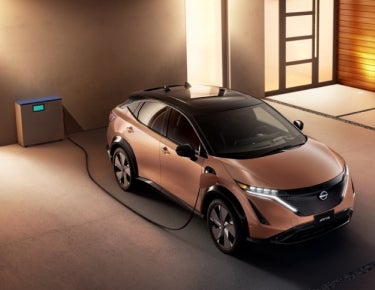 Nissan ARIYA plugged-in and charging outside a home | Casa Nissan in El PASO TX