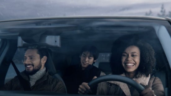 Three passengers riding in a vehicle and smiling | Casa Nissan in El PASO TX