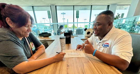 Woman with completed finance application and satisfactory terms at Casa Nissan dealership