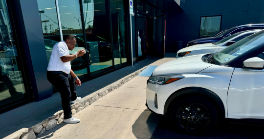 Man taking photos at Casa Nissan for Trade in Offer on Vehicle