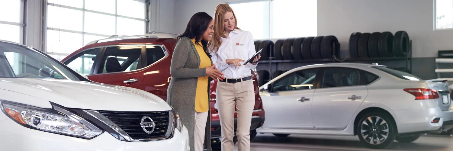 Nisssan Dealership Employee helping customer out